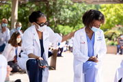 Dr. Clarissa Johnson comforted Dr. Alecia Nero as attendees knelt to honor George Floyd.