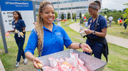 Dawn Cureton welcomes attendees to grab a bag of complimentary popcorn.