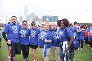 A group mugs for the camera in front of the Dallas skyline.