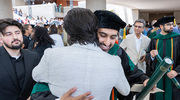 Umer Nadir, M.D., hugs a family member after the emotional ceremony.