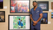 Dwayne Bio stands beside his winning digital artwork piece, Love is Free; Freedom is Not, based on a sketch of two young sisters in the West African country of Sierra Leone. Mr. Bio’s work also won the People’s Choice award and tied for Best in Show.