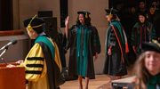 Morayo Lawal, M.D., waves to her loved ones as she crosses the stage.