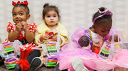 Sampling their Halloween candy are three adorable young trick-or-treaters.