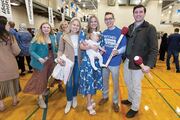 William “Craig” Kemper holds a giant “Match”-stick prop surrounded by his family.