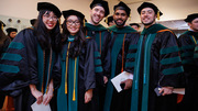 From left: Graduating Drs. Stephanie Ngo, Anh Ngo, Micah Newton, Aman Narayan, and Aamer Naofal gather for a group photo.