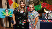 Ms. Hargrove and Ms. Lara pose in front of art prior to the session.