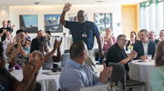 Software System Specialist Albert Garner, a Gold PACT pin recipient, is cheered on by his peers at one of the summer ice cream socials for his outstanding commitment to the PACT standards: problem solving; ability, attitude, and accountability; communications and compassion; and teamwork.