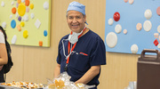 Registered Nurse Victor Resendiz is all smiles as he lines up for food.