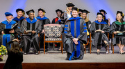 Mentor Laura Lacritz, Ph.D., Professor of Psychiatry and Neurology, adjusts the hood of Clinical Psychology graduate William Goette, Ph.D., M.S.