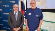 Medical Technologist Gary Gaulden (right) stands beside UTSW President Daniel K. Podolsky, M.D., as he is congratulated on 45 years of service during the annual Quarter Century Club celebration event on June 7.