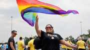 At the parade, a rainbow fan flows in the spirit of the festivities.