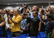 Stand by! Friends and family have their cameras ready to capture the graduates' arrival.