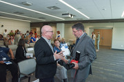 Dallas artist John Pomara visits with Dr. Claus G. Roehrborn, Professor and Chairman of Urology.