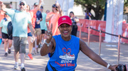 A team member strikes a pose at the finish line.