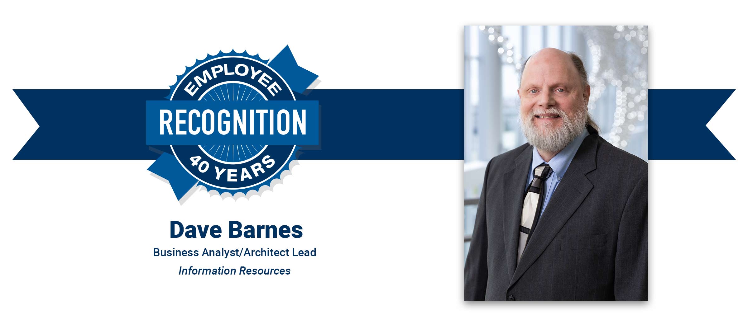 Man with gray beard, wearing a suit. David Barnes, 40 years employee recognition.