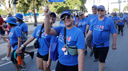 A walker proudly waves her Heart Walk flag.