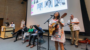 Singer-guitarist Jan Garcia, a Clinical Research Coordinator, performs accompanied by Jacob Frie, a Senior Business Analyst, on tenor saxophone.