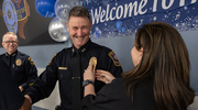 UT Southwestern Assistant Chief of Police Pete Amaral is sworn in at a ceremony in September. The new Assistant Chief, whose wife, Jennifer, pins on his badge, previously worked at the Grand Prairie Police Department. He said of UTSW: “The culture and staff here are second to none.”