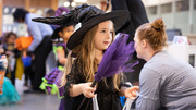 This cute little witch holds out her bag for some treats.