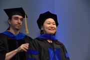 Dr. Brad E. Pfeiffer, Assistant Professor of Neuroscience hoods Dr. Mengni Wang, who earned her doctorate in neuroscience.