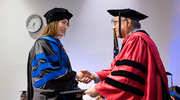 Yin Gao, Ph.D., M.S., receives her degree from Daniel K. Podolsky, M.D., President of UT Southwestern. She was one of more than 80 students to complete her education at UT Southwestern’s Graduate School of Biomedical Sciences.