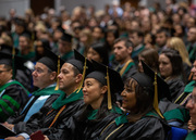 Faculty mentors and Medical School leaders watch the ceremony with pride.