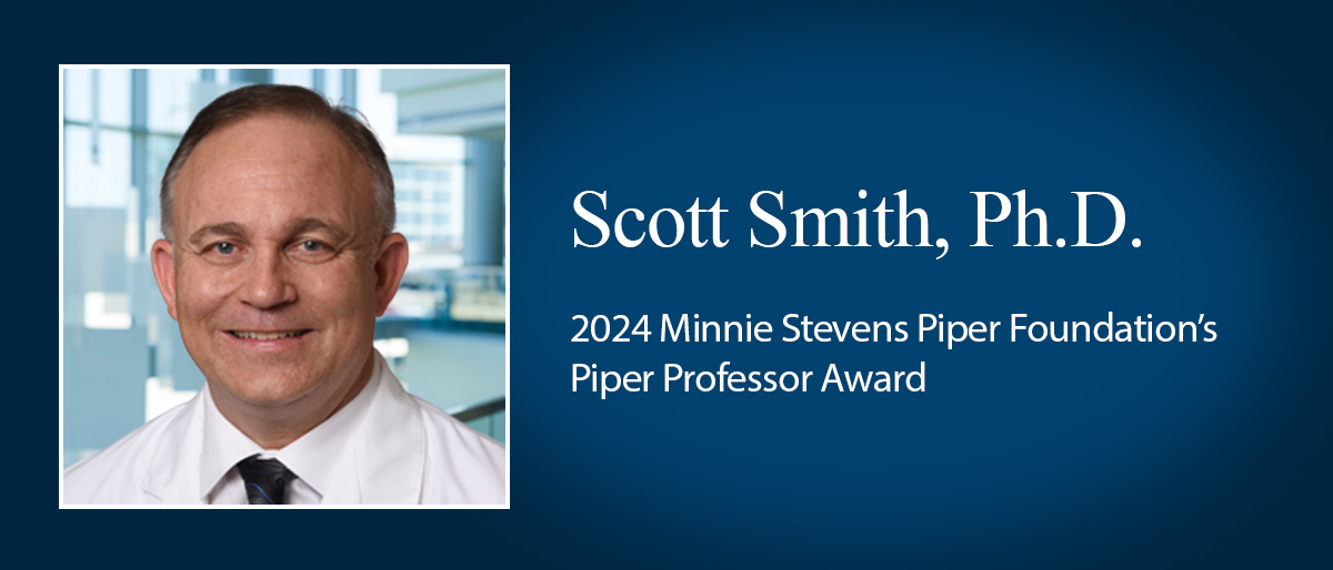 Smiling man with brown graying hair, wearing a white lab coat over white shirt and dark tie. Scott Smith, Ph.D., 2024 Minnie Stevens Piper Foundation, Piper Professor Award