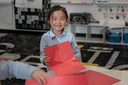 This student is so happy to decorate cards this Valentine’s Day.