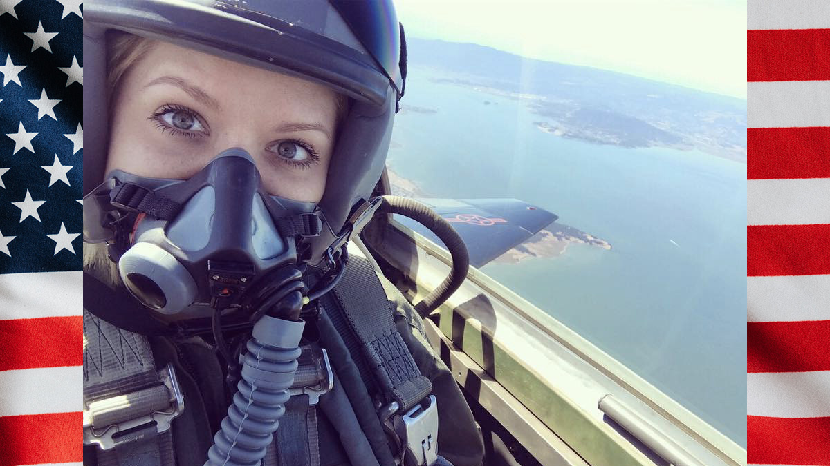 Woman in figher jet with helmet and oxygen mask on