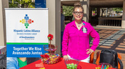 Judith Ramos of the Hispanic-Latino Alliance Business Resource Group staffs a booth with free goodies for attendees.