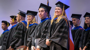 Graduate School program directors stand as the graduates walk into the Gooch Auditorium for the ceremony.