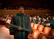 Dr. Yemi Afuwape, an M.D./Ph.D. graduate, with diploma in hand.