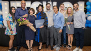 Clinical Psychology graduate Afsoon Gazor, Ph.D., M.Ed. (fourth from left), celebrates with Biomedical Engineering graduate Zachary Bennett, Ph.D. (fifth from left), friends, and family.