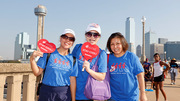 Three walkers combine their support with staying cool as they cross a downtown bridge along the walk.