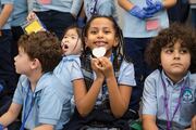 Fromee Menegesha, center, shows off her plastic heart.