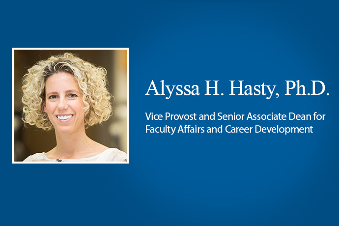 Smiling woman with curly blond hair in a blue banner with copy - Alyssa H. Hasty, Ph.D., Vice Provost and Senior Associate Dean for Faculty Affairs and Career Development