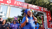 A walker completes his journey with a young guest on his shoulders.