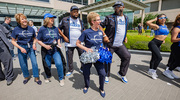 UT Southwestern staff members (from left) Julie Olson, Cindy Olson, and Patricia “Patty” Ferme dancing with Mavs Maniaacs.