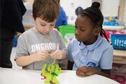 Two students work together to assemble the hand with veins in one of Biomedical Preparatory’ s STEM classes.