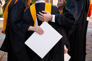 Classmates come together for a group hug after the ceremony.