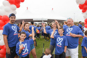 A group of walkers point to the UTSW banner at Reverchon Park