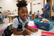 This young student is all smiles while working on her craft project.