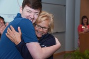 Nursing Resident Zechariah Thompson andClinical Educator Kathie Waldron share a hug at the July graduation ceremony.