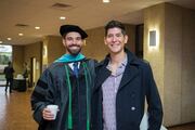 Physical Therapy graduate Ronald “Rocky” Rodriguez poses with a friend for a photo.