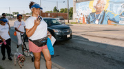 During the walk, a UTSW community member strikes a pose near the mural of Dallas civil rights activist Juanita Craft.