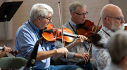 Dr. Quigley pays careful attention to hitting the right notes when playing his viola.