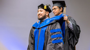 Paul Acosta, Ph.D., is hooded by his mentor, Satwik Rajaram, Ph.D., Assistant Professor of Pathology and in the Lyda Hill Department of Bioinformatics and the Center for Alzheimer’s and Neurogenerative Diseases.