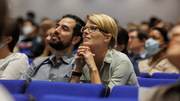 Listening intently are members among the packed audience.