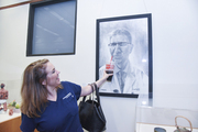 Mary Heather Fyfe clowns around with her portrait of Dr. Claus Roehrborn.