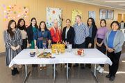 Event participants pose with employees of the Division of Diversity and Inclusion at the Mid-Winter Social.